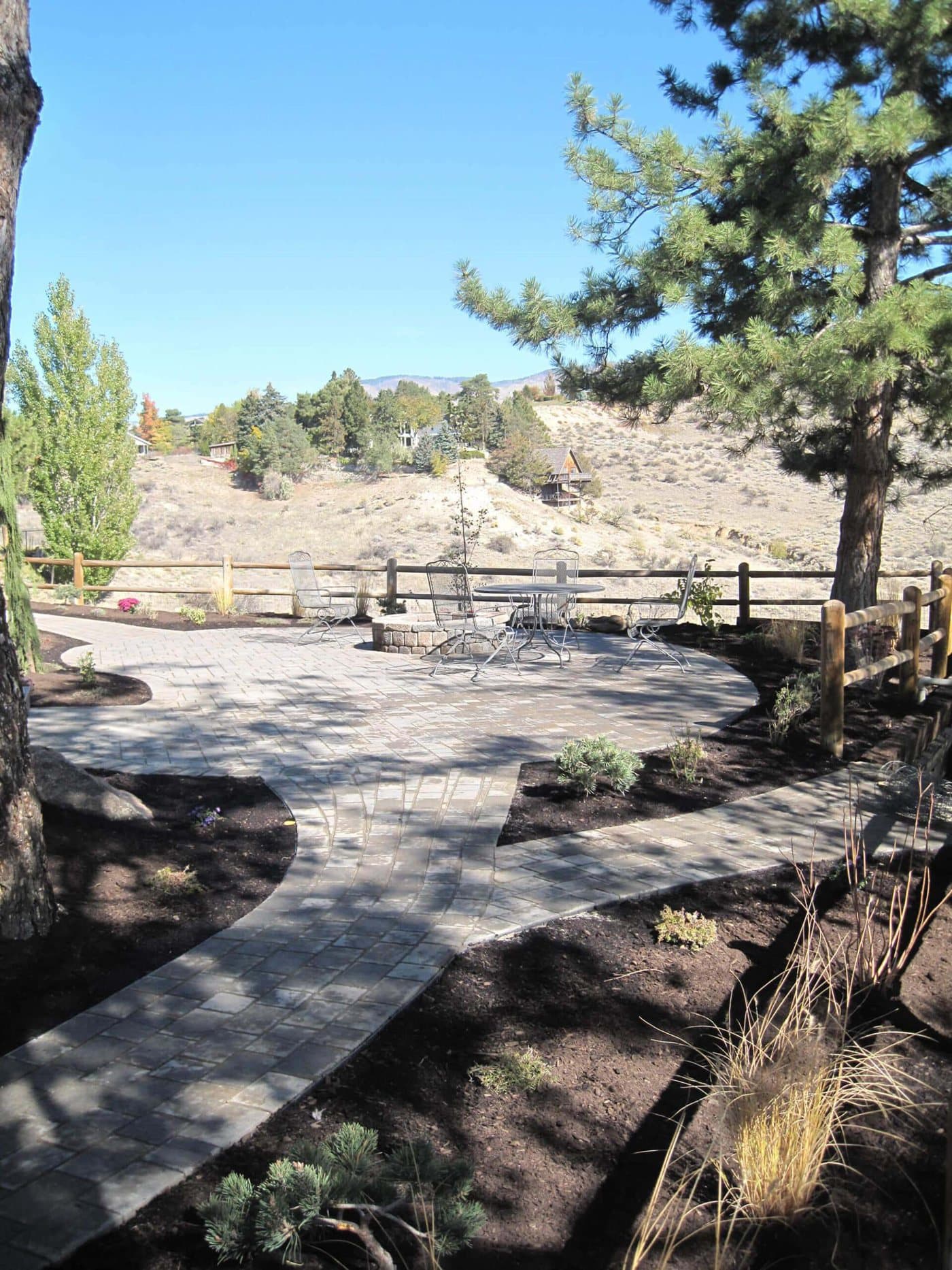 Expansive custom paver patio with seating area in a Boise backyard