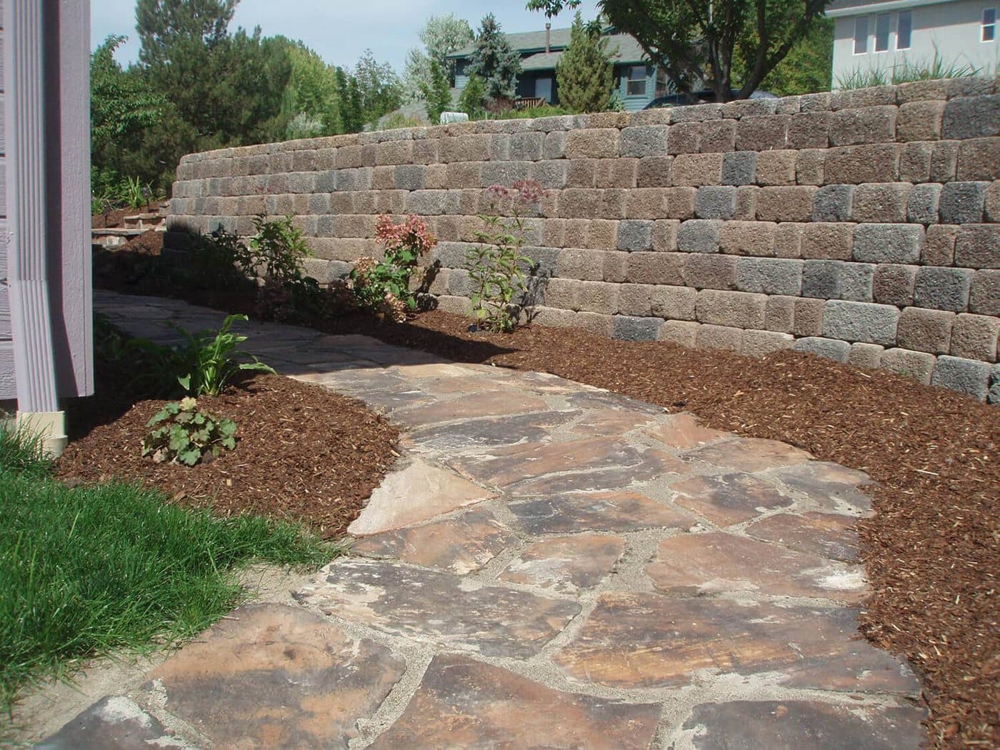 Flagstone patio and natural stone steps installed by TLC Landscape