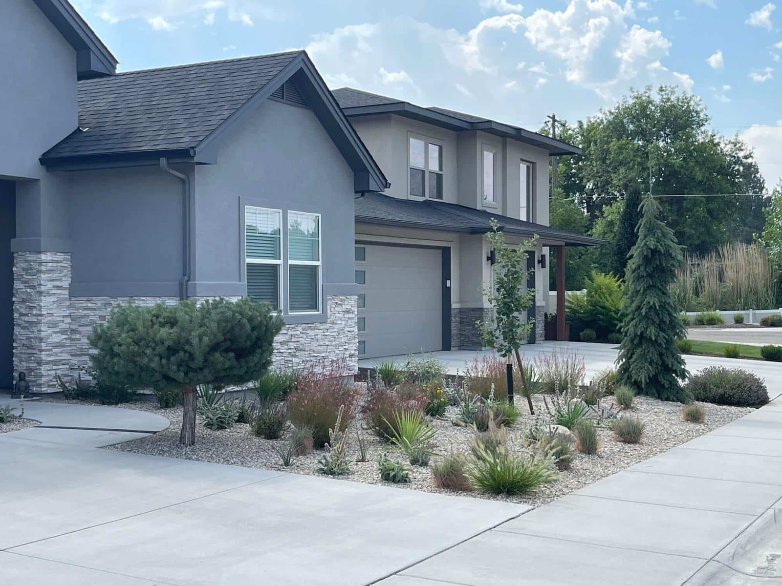Tiered retaining wall and landscaped front yard by TLC Landscape