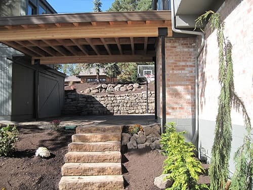 Natural stone retaining wall with built-in steps