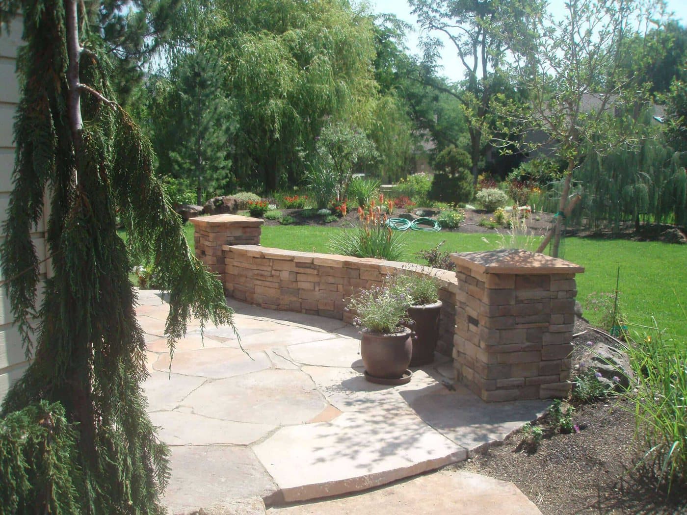 Custom paver patio with curved borders in a Treasure Valley backyard